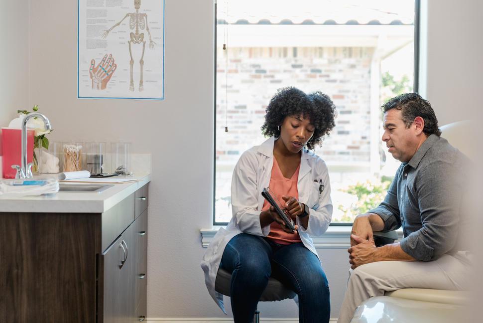 Physician reviewing medical results with patient during a personalized primary care visit in Westport CT